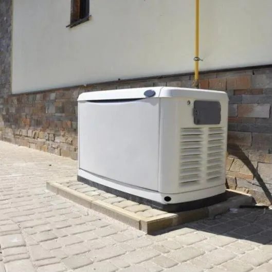 Home standby generator installed beside a house
