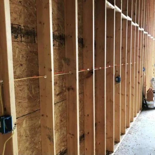 Electrical rough-in wiring on a new construction wall